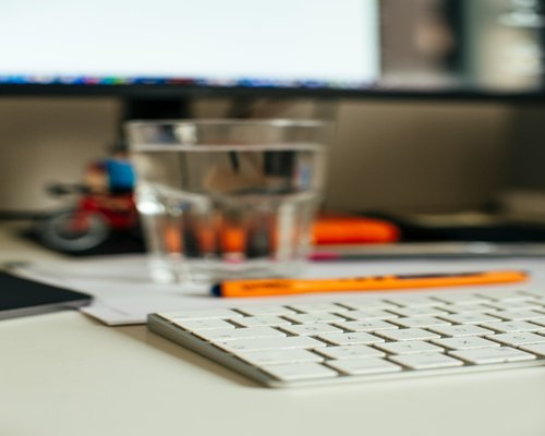 Fresh fruits and a glass of water on an office desk