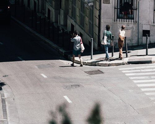 Person walking comfortably on a sunny city sidewalk